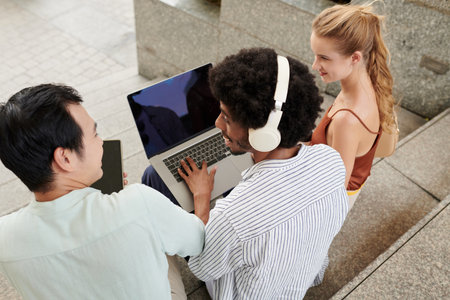 Smiling coworkers discussing new project when spending break outdoorsの写真素材