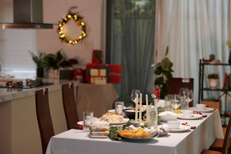 Dinner table with various traditional Vietnamese dishes served for family Christmas celebrationの写真素材