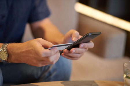 Hands of businessman paying with credit card for online services