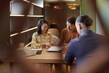 Positive business team meeting in restaurant to discuss contract termsの写真素材