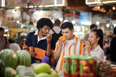 Group of young people walking in local market looking for fresh organic fruits and vegetablesの写真素材