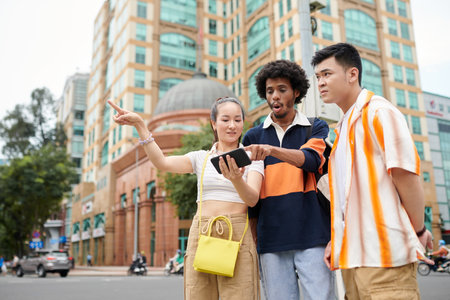Friends lost in city using map on smartphone when searching for destinationの写真素材