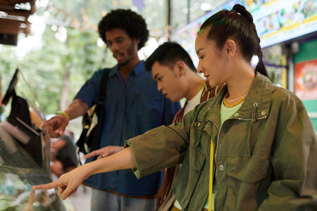 Group of friends discussing what to buy for dinner at local market