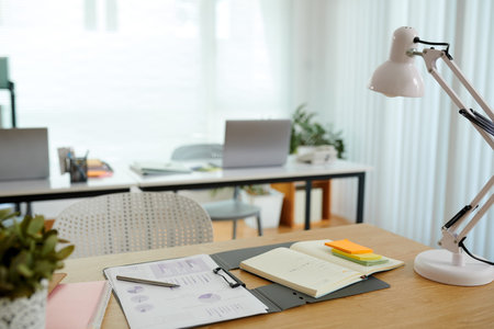 Opened planner and report on office desk of marketing managerの写真素材