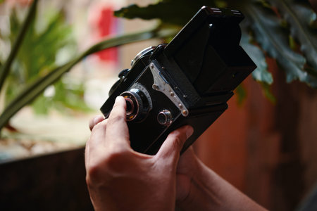 Closeup image of photographer checking if his old camera words