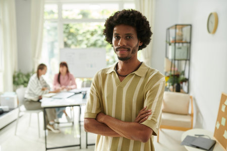 Smiling confident community manager standing in light cozy small company officeの写真素材