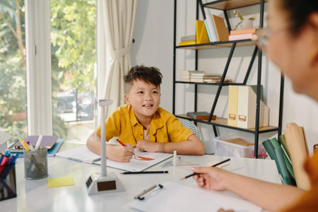 Excited kid drawing planet in class after learning about renewable energy sources