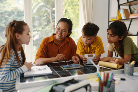 Curious kids learning about renewable energy in classの写真素材