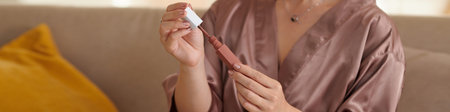 Banner with woman in silk robe opening matte  lipstick