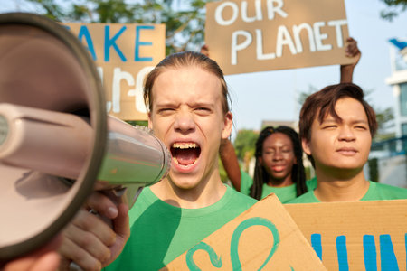 Eco-volunteer shouting in loud speaker when leading strike