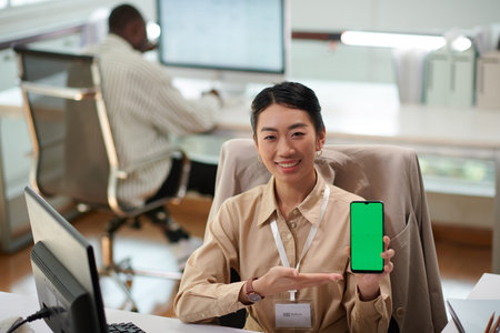 Head of bank research and development department showing smartphone with green screenの写真素材