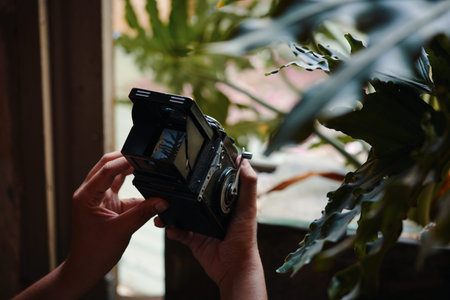 Creative photographer learning how to take photos with analog camera