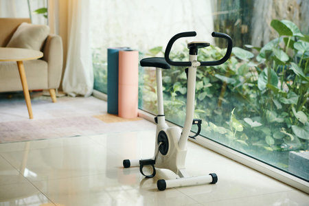 Exercise bike in spacious room next to panoramic window