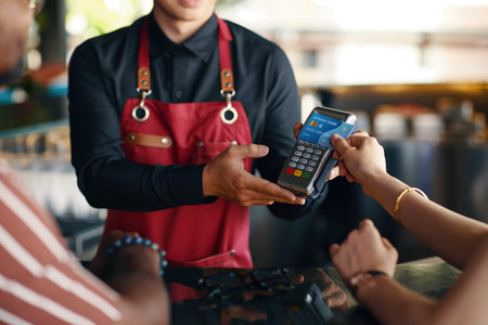 Woman paying for dinner in restaurant with credit card