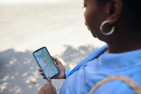 Woman tracking taxi car on map via mobile applicationの写真素材