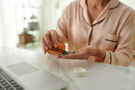 Sick woman taking painkillers dailyの写真素材