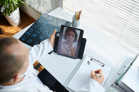 General practitioner having telemedicine session with sick patient