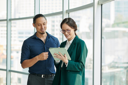 Positive businesswoman signing document on tabletの写真素材