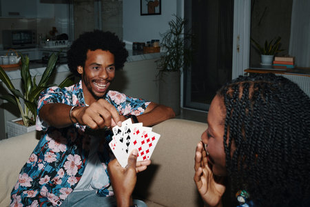 Excited man pulling card from hands of girlfriend