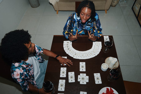 Young Black woman doing tarot spread for best friend