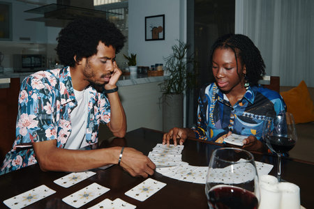 Serious Black man pulling tarot card from spreadの写真素材