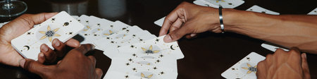 Web banner with hands of people doing tarot spread