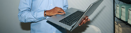 Header with office manager checking emails on laptop