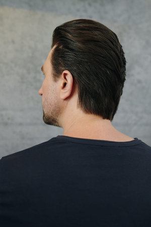 Man with fresh voluminous haircut looking away