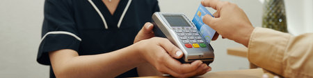 Woman paying for beauty procedure with credit cardの写真素材