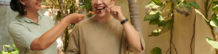 Header with couple eating kebabs at barbeque party