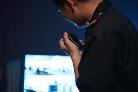Man Talking By Radio In Security Room
