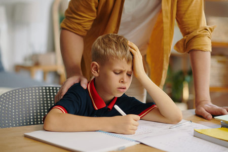 Schoolboy Doing Homework With His Dad