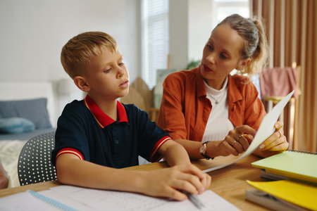 Mother Explaining Topic To Her Sonの写真素材