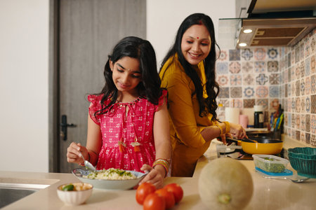 Daughter Helping Her Mom In The Kitchenの写真素材