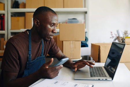 Man Using Laptop In Storage Room