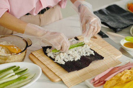 Woman Making Korean Kimbap In The Kitchenの写真素材