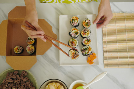 Woman Packing Homemade Kimbap In Lunchboxの写真素材