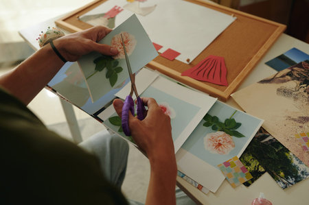 Man Making Design Collage At Tableの写真素材