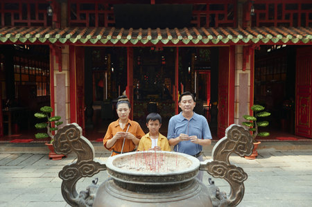 Asian Family Praying Together With Sonの写真素材