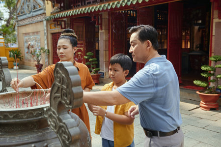 Buddhist Family Praying With Aroma Sticksの写真素材