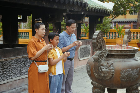 Family With Aroma Sticks Visiting Templeの写真素材