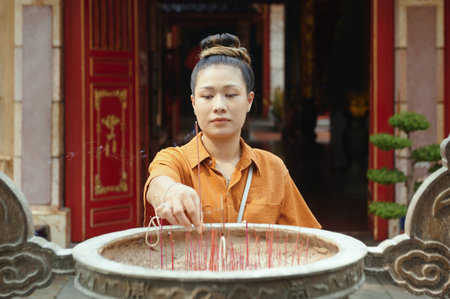 Buddhist Woman Using Aroma Sticksの写真素材
