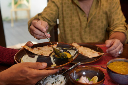 Man Treating His Guest During Dinnerの写真素材