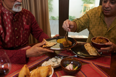 Friends Eating Indian Food During Dinnerの写真素材