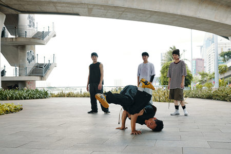 Performing Breakdance Moves Under Urban Bridge