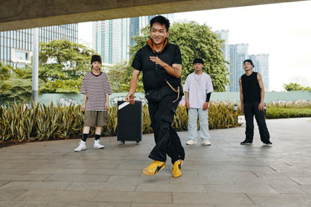Dancing Outdoors with Friends in Urban Park Settingの写真素材