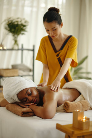 Providing Relaxing Massage in Serene Spa Settingの写真素材