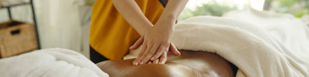 Receiving Relaxing Back Massage at Wellness Spaの写真素材