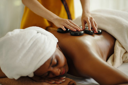 Enjoying Relaxing Hot Stone Massage at Spa Centerの写真素材