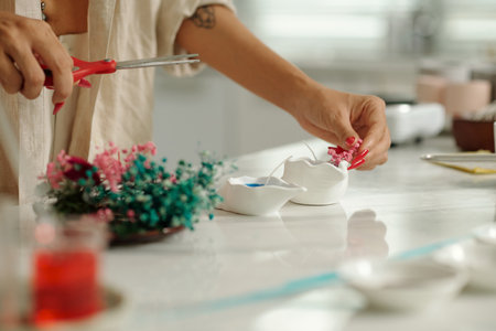 Woman Using Dried Flower To Make Candlesの写真素材